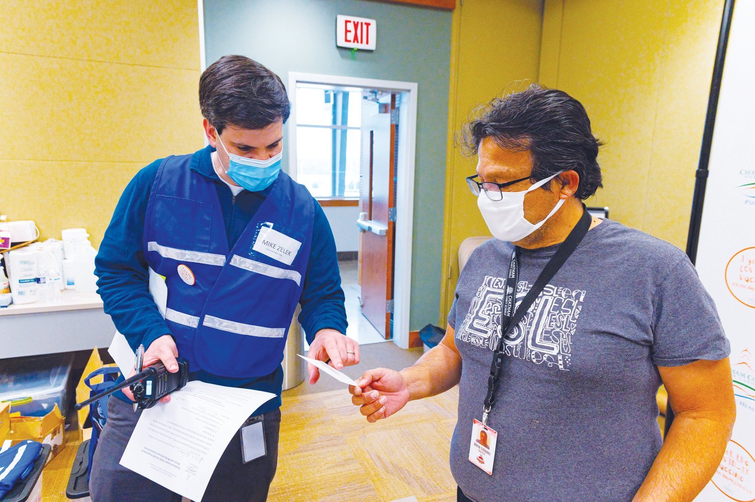 Chatham County Public Health Director Mike Zelek hands Alirio Estevez his second-dose appointment slip during a vaccination event earlier this year.